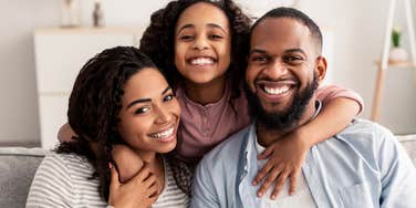 happy family smiling on the couch