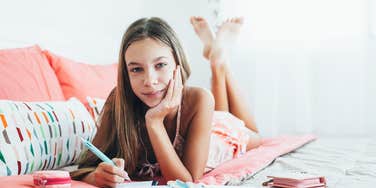 Tween girl sitting spending time alone in her bedroom