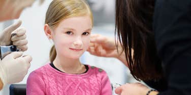 Daughter getting her ears pierced