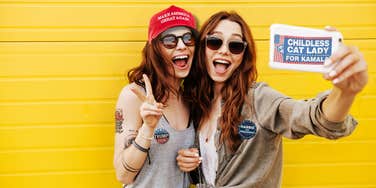 Two friends supporting different political parties taking a selfie