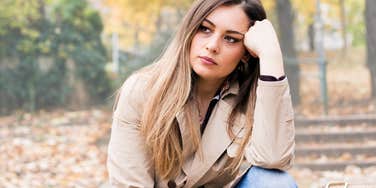 Woman looking sad while thinking about her sad parents. 