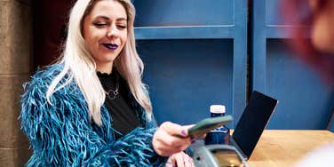 Woman paying tab while on date