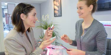 Woman choosing polish color at nail salon