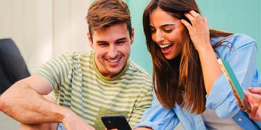 couple looking at their phones to see if they can hear the silent gif