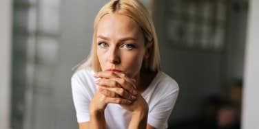 Woman looking serious, experiencing effects of relationship with narcissist