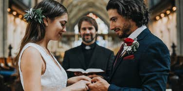 bride and groom at the altar holding hands