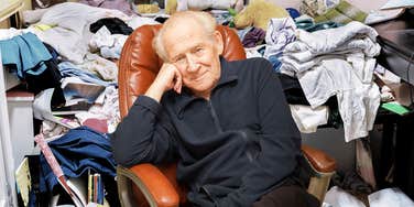 Senior man sitting in his recliner surrounded by clutter.