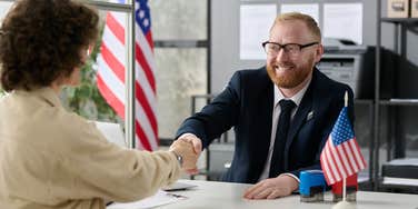 Woman getting United States green card and welcome pamphlet