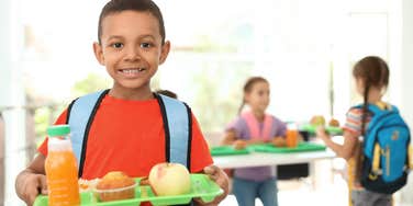 Kid holding school lunch tray