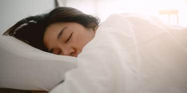 close up shot of woman sleeping in bed