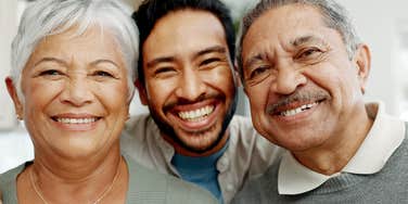 smiling man in between happy parents