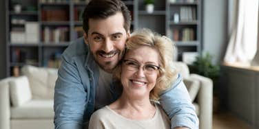 grateful son hugging mom from behind