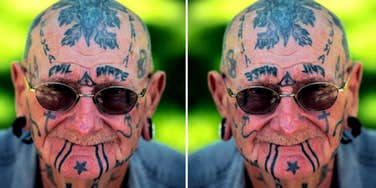 old man with tattooed head and face