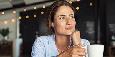 Woman drinking coffee alone