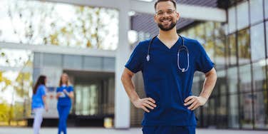 nurse standing outside of a hospital