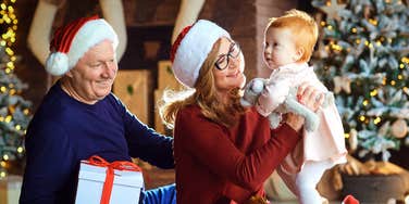 Grandparents sharing Christmas presents with grandchild