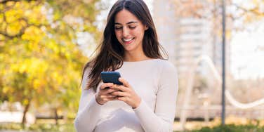 Woman texting on her cell phone