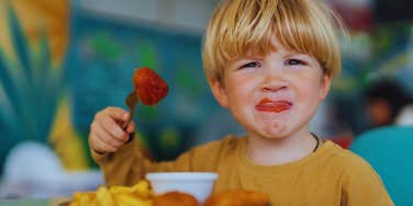 little boy eating at restaurant 