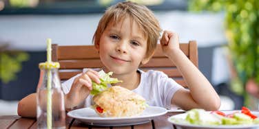 Kid eating at a brewery