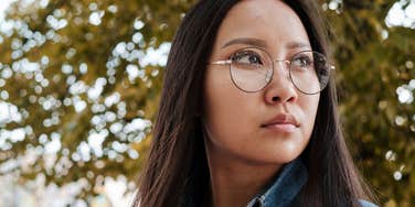 Asian girl wearing glasses and having a photoshoot in the park.