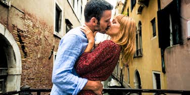 Couple kissing while on a romantic destination vacation.