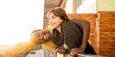 Happy couple on balcony.