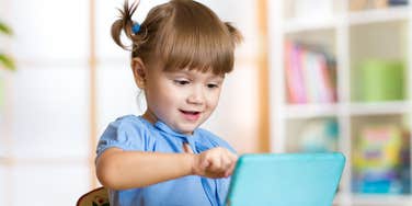 Cute little girl using iPad