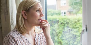 Concerned woman looking out the window