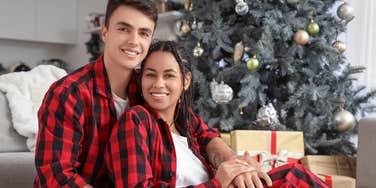 Couple wearing matching holiday pajamas