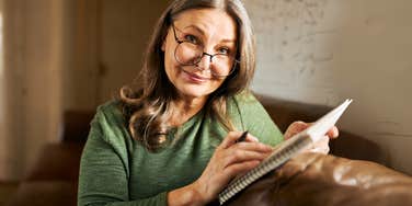 Boomer woman handwriting a letter of appreciation. 