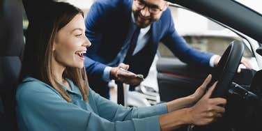 Woman buying a car from a car dealership