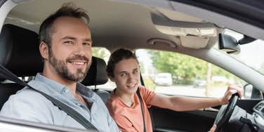 father and son driving in car together