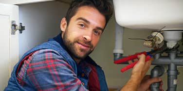 Plumber working on sink