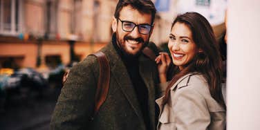 Couple flirting casually after bumping into one another on the street. 