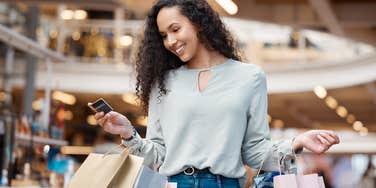 Woman shopping holding bags and credit card