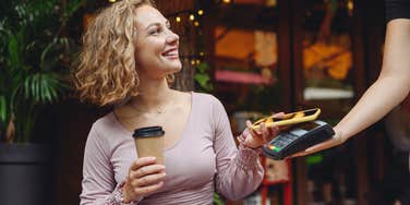 Young woman buying coffee 