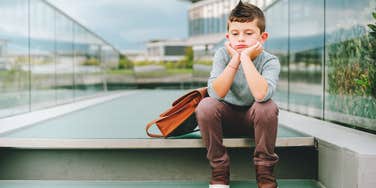 Son waiting at school for his parents