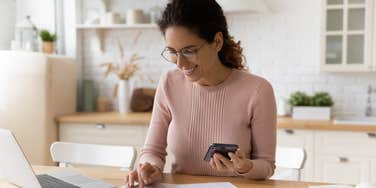 Mom happily looking at how her savings have added up over a year