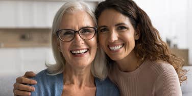 mother and daughter smiling at the camera