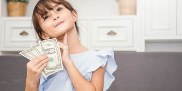 Little girl holding Christmas money