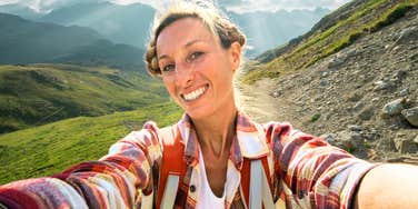 Woman hiking, taking a mental break.