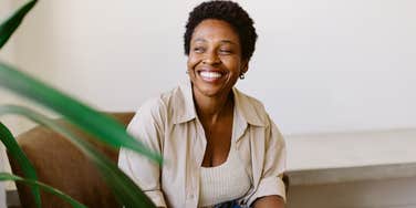 smiling, happy woman sitting in chair