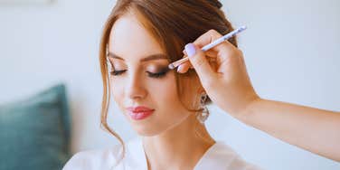 bride getting makeup done