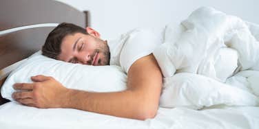 Man sleeping in his bed at home