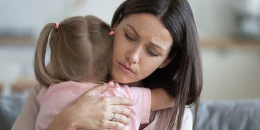 Mom comforting her daughter who wasn't invited to a party