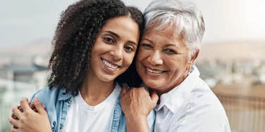 mom and daughter smiling and hugging