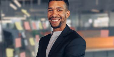 Professional man smiling at the camera in his office.