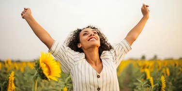 Woman standing in sunflower field