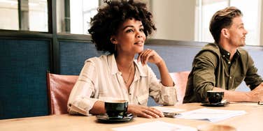 Well respected woman, listening intently at meeting with others. 