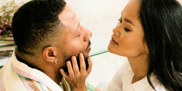 Woman touching mans face, whose love language is touch.